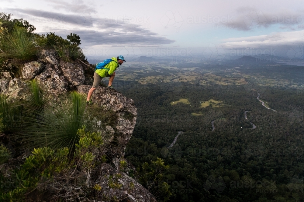 Man looking out from mountain top - Australian Stock Image