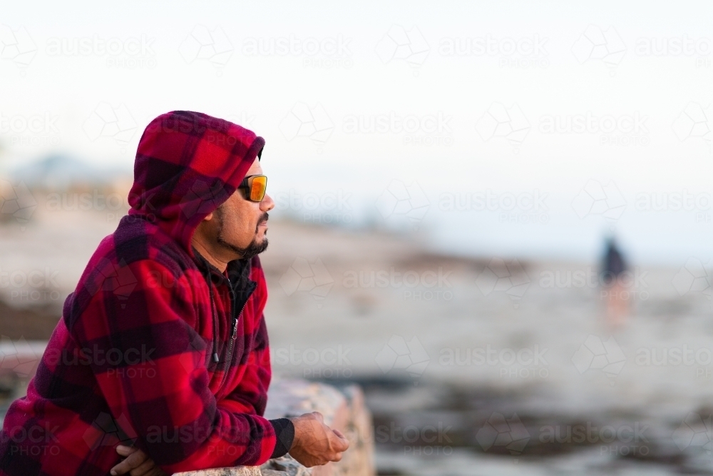 Man looking out in distance with blurred figure in background - Australian Stock Image