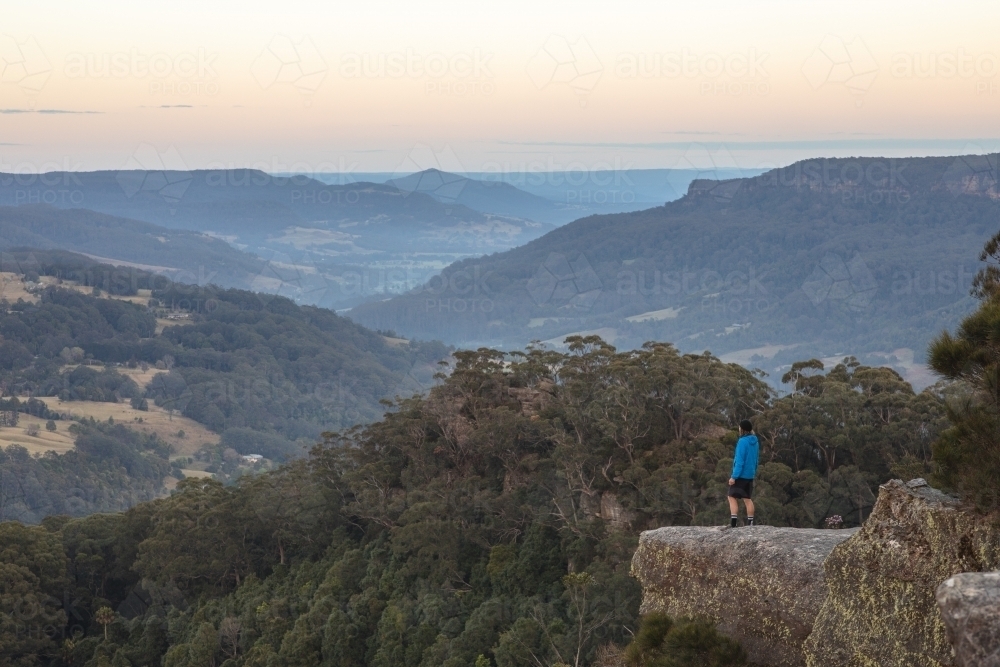 Man looking out over mountains - Australian Stock Image