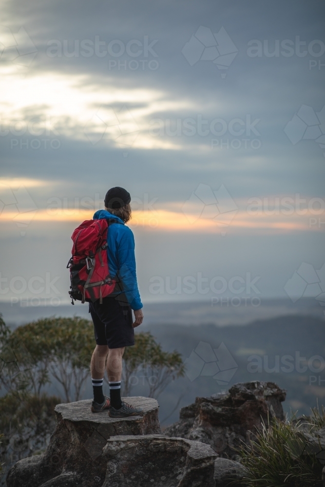 Man looking out over mountains - Australian Stock Image