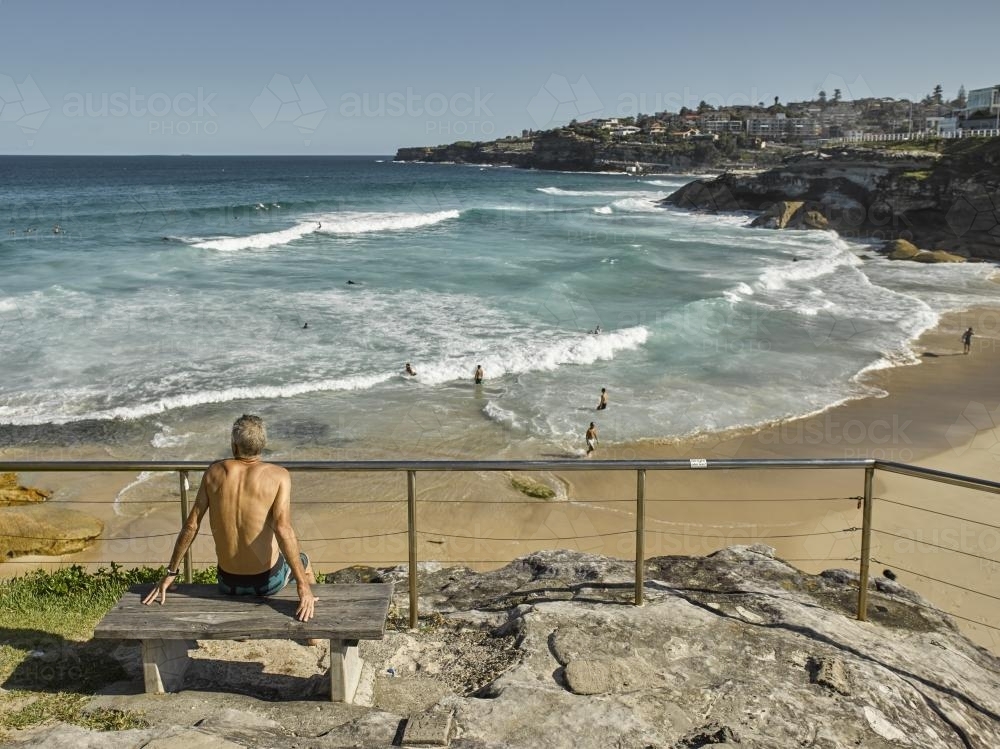 man looking out over Tamarama beach - Australian Stock Image
