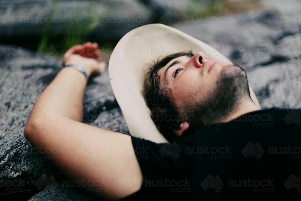 Image of Man lying down outside - Austockphoto