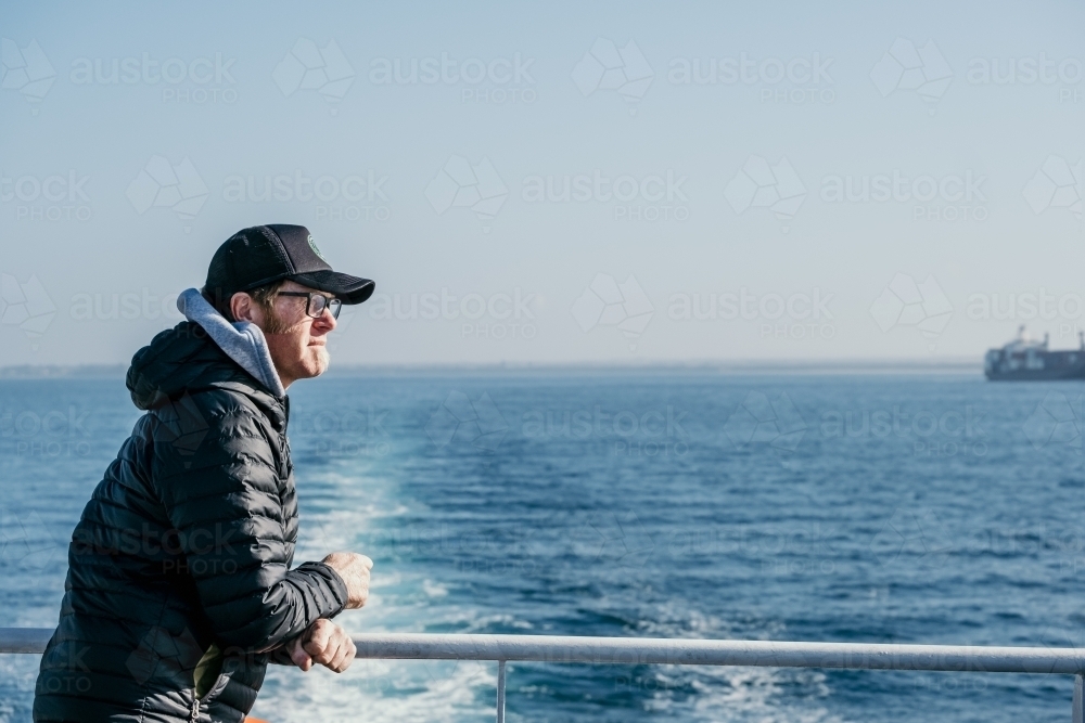 Man on ferry boat. - Australian Stock Image