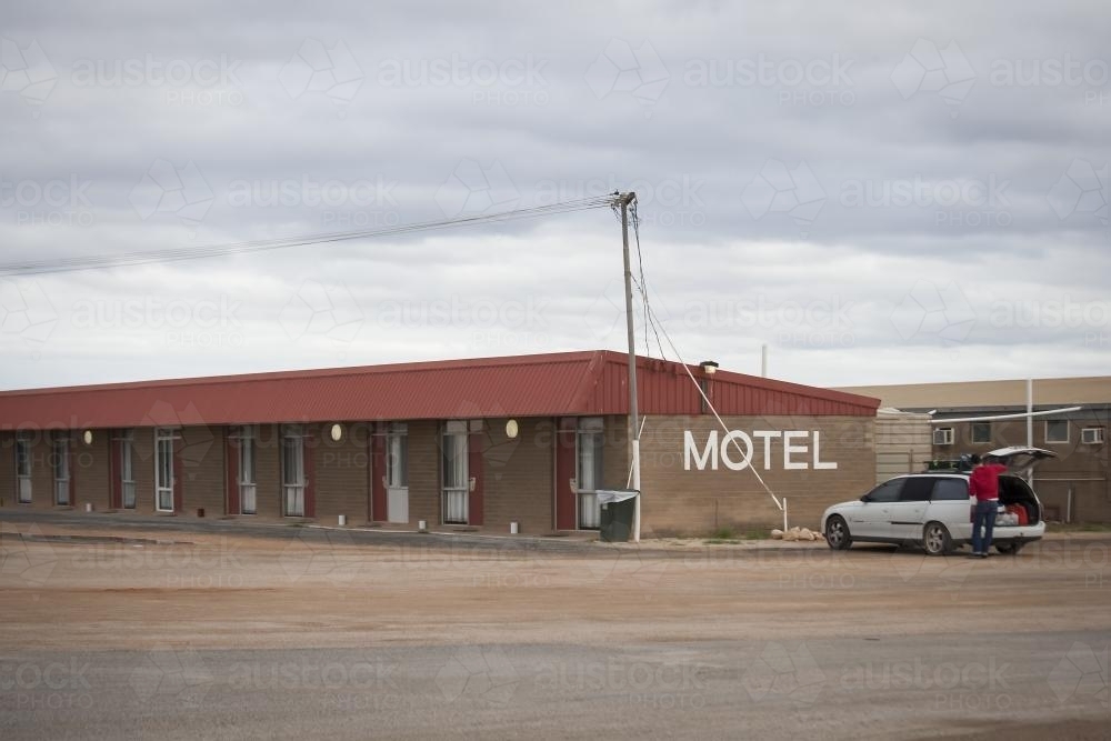 Man packing car at Motel on the nullarbor - Australian Stock Image