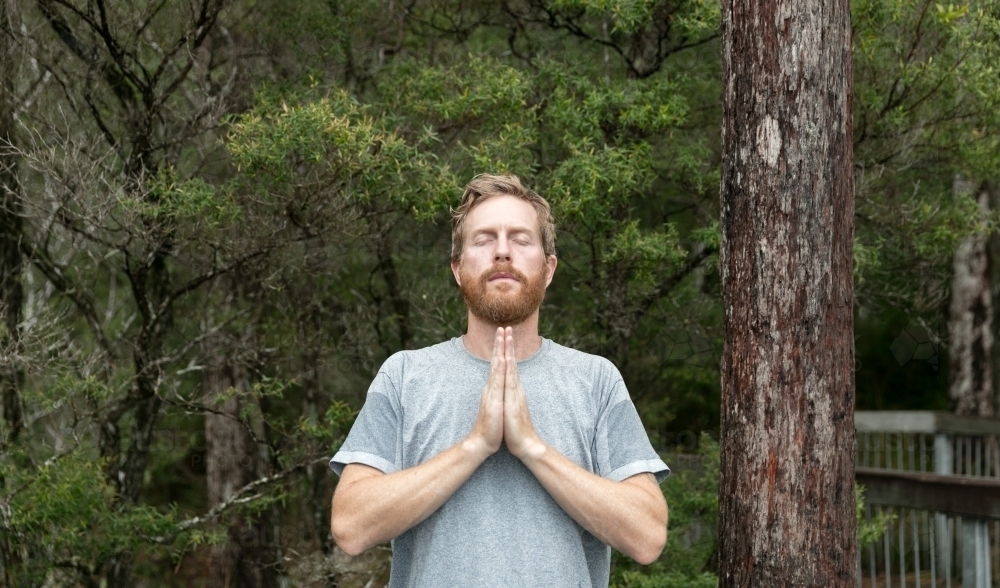 Man praying in the forest - Australian Stock Image