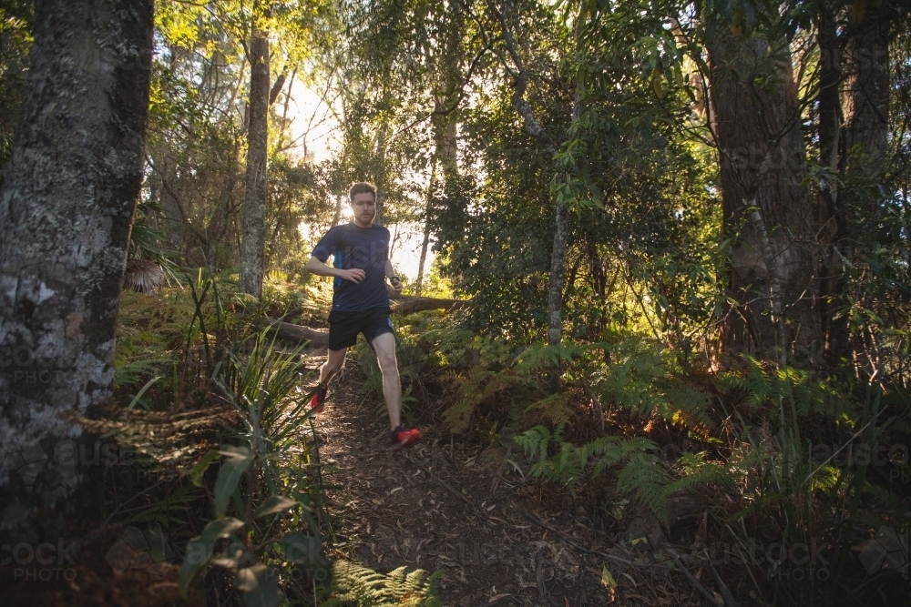 Man running towards camera in bush setting - Australian Stock Image
