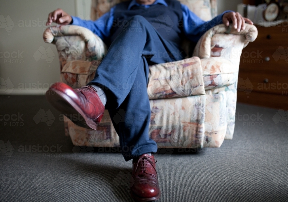 Man sitting in chair - Australian Stock Image