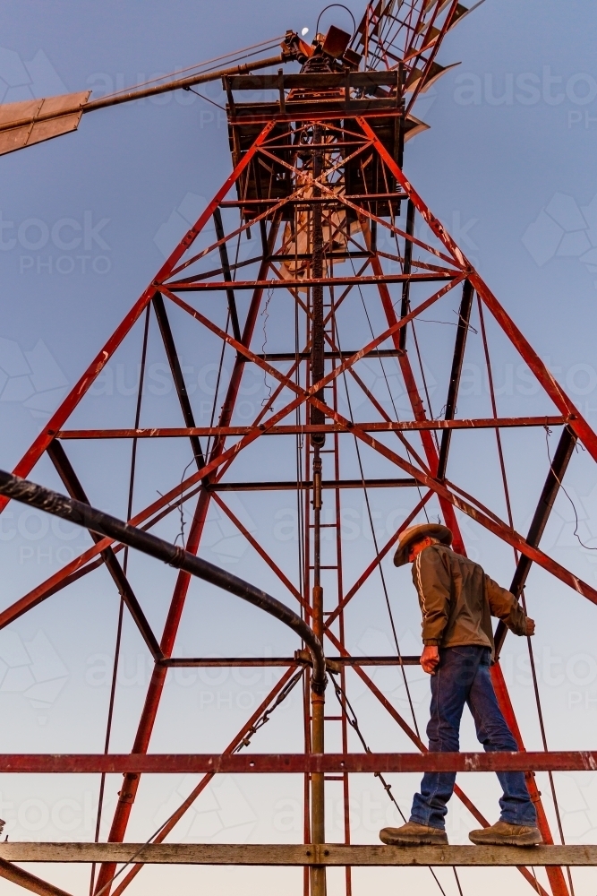 Man standing on a windmill tower - Australian Stock Image