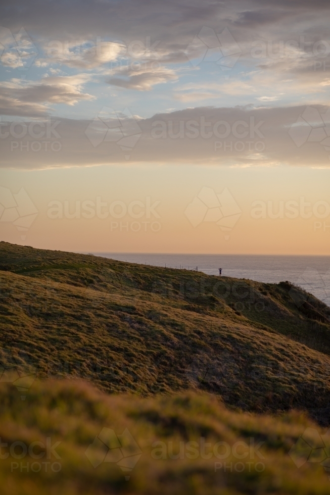 Man standing on hillside - Australian Stock Image