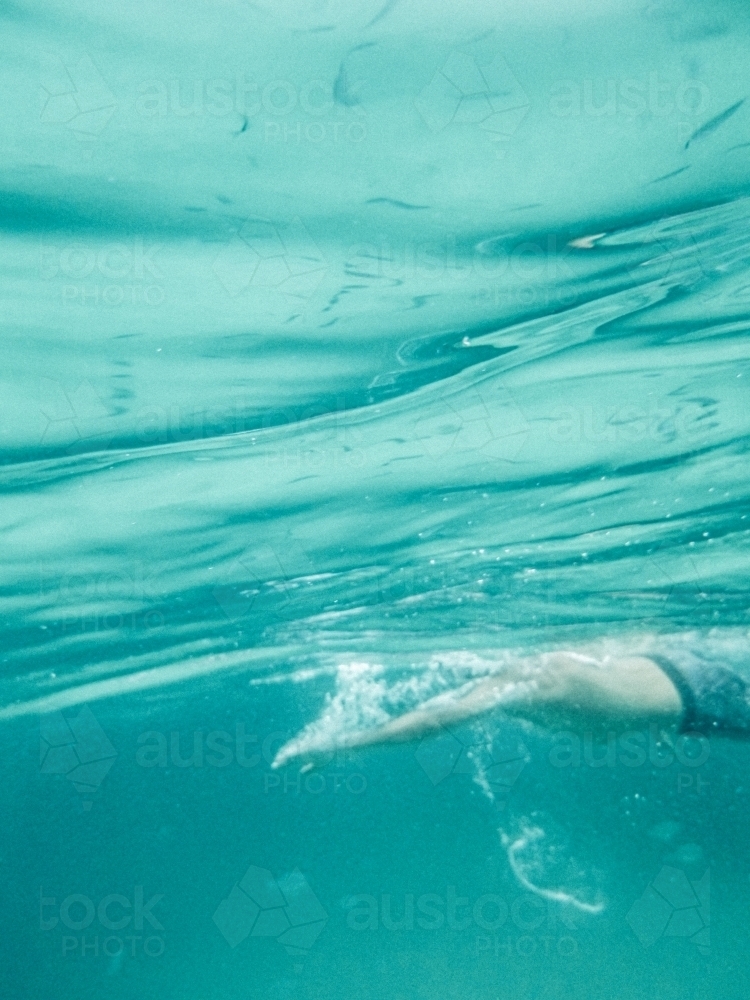 Man swimming shot from underwater - Australian Stock Image