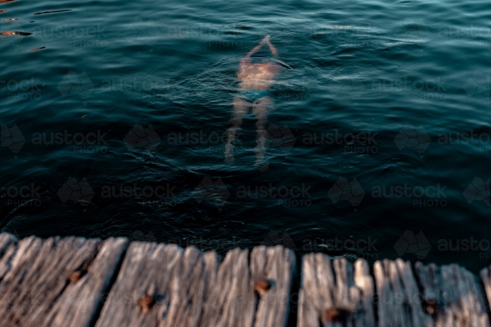 Man swimming underwater - Australian Stock Image