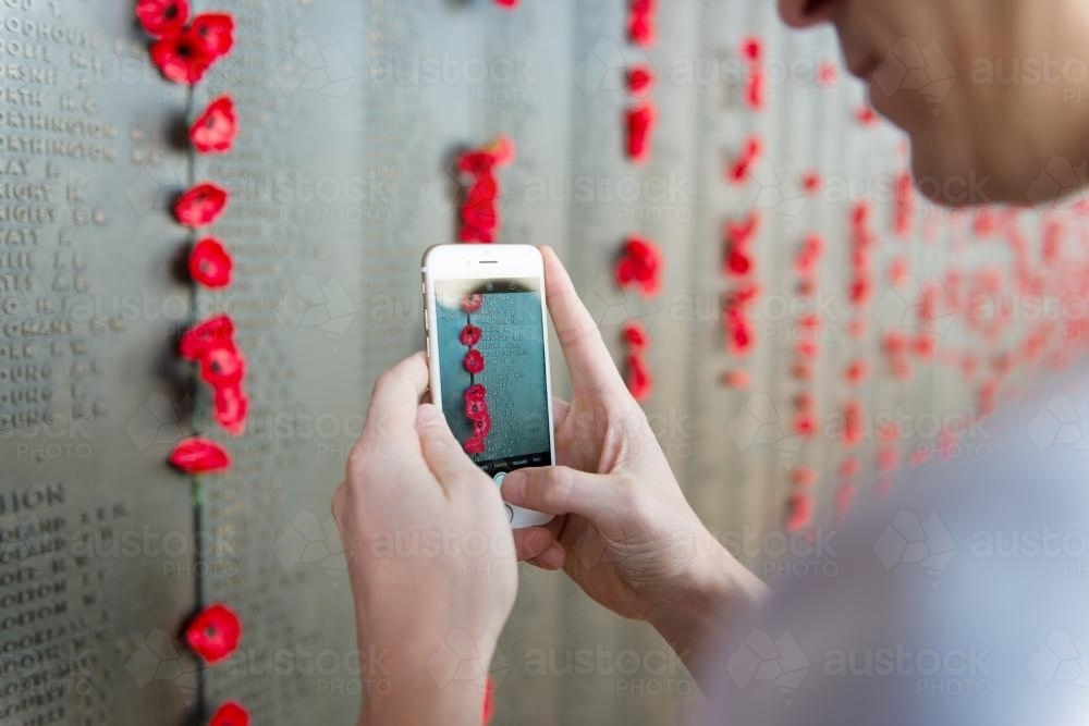 Man taking a photo with his mobile phone at the Australian War Memorial - Australian Stock Image