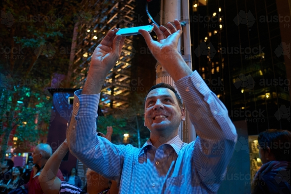 Man taking photos at night in City of Sydney - Australian Stock Image