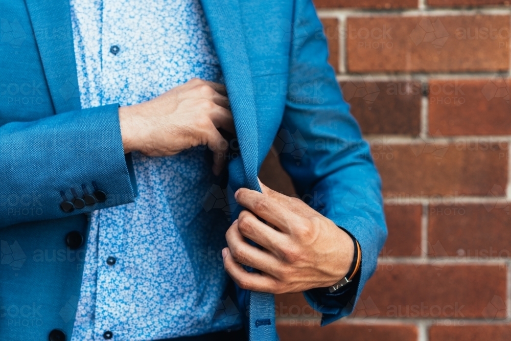 man taking something out of his suit jacket - Australian Stock Image