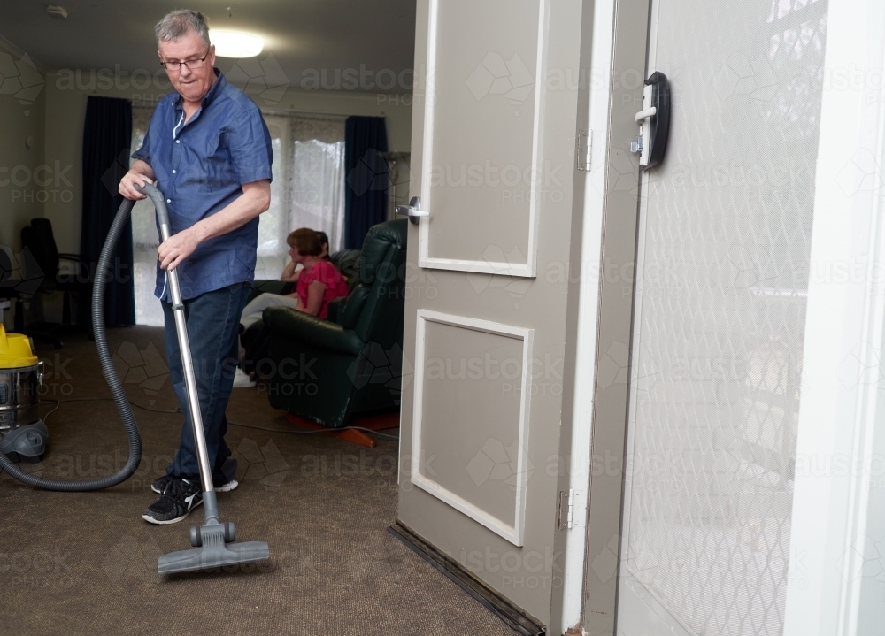 Man Vacuuming - Australian Stock Image