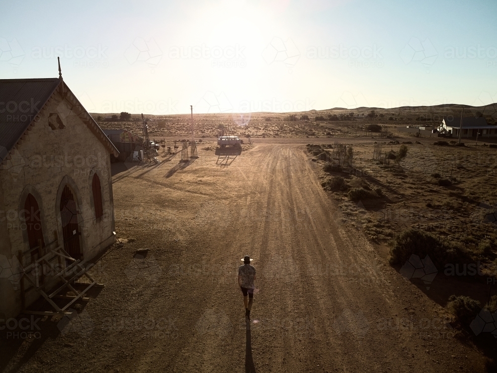 Man walking down the main street of Silverton, New South Wales - Australian Stock Image