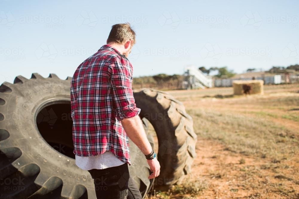 man walking on a farm - Australian Stock Image