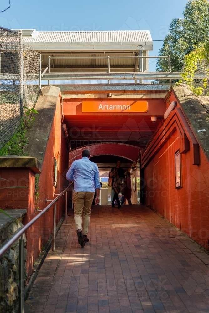 man walking to train station - Australian Stock Image