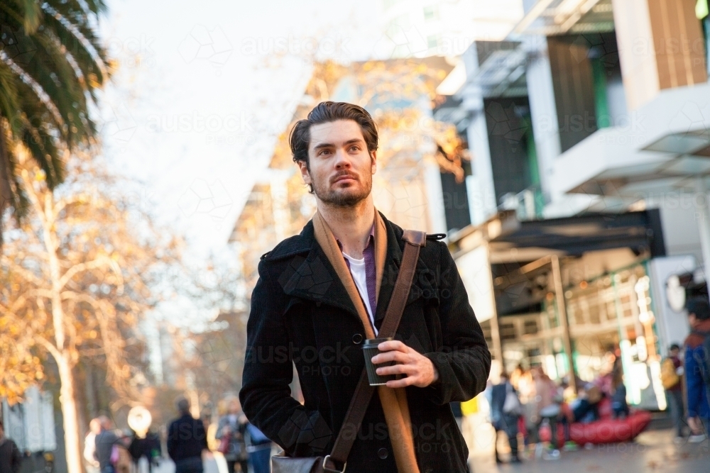 Man Walking to Work with Morning Coffee - Australian Stock Image