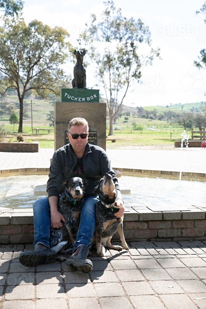 Man with his 2 dogs at the dog on the tuckerbox in Gundagai - Australian Stock Image