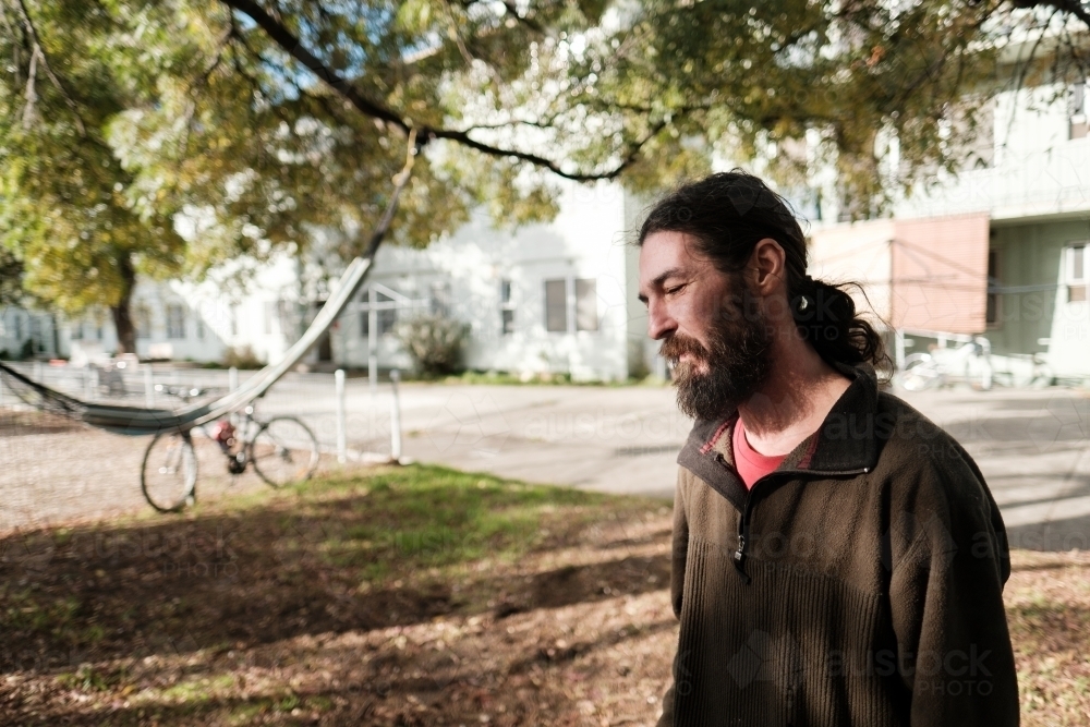 Man with Long Hair and Beard in his Backyard - Australian Stock Image