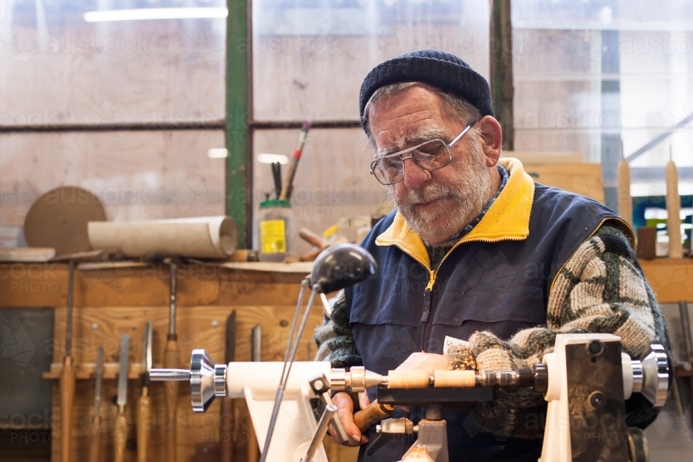 Man working on a lathe at a men's shed - Australian Stock Image