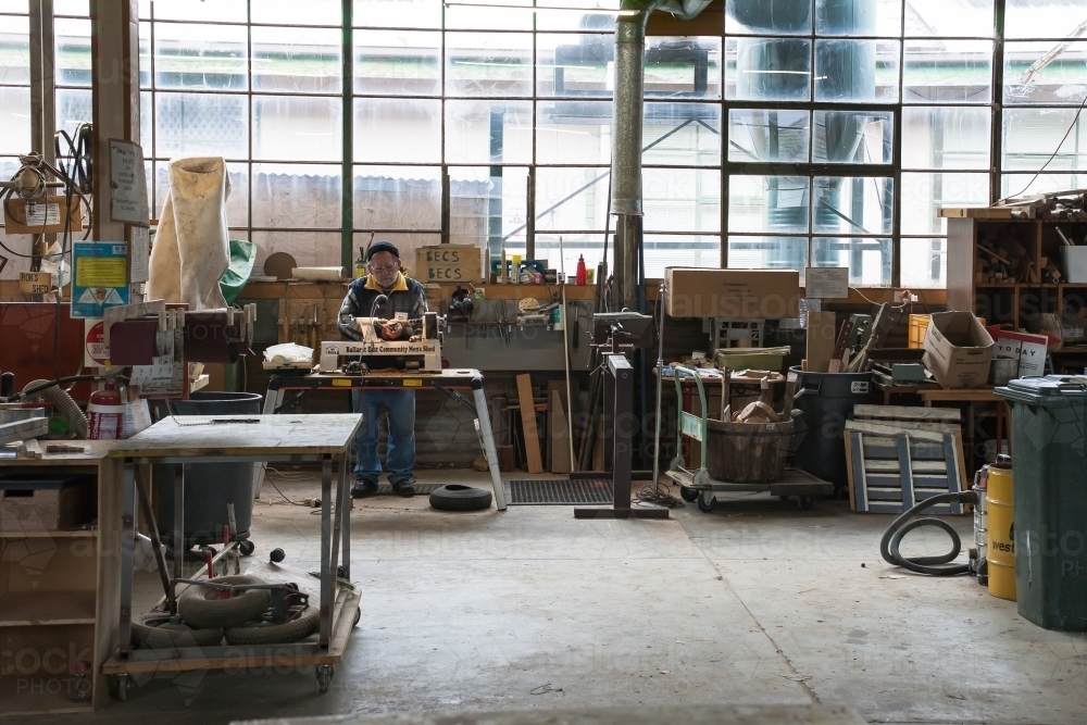 Man working on a lathe in a men's shed - Australian Stock Image