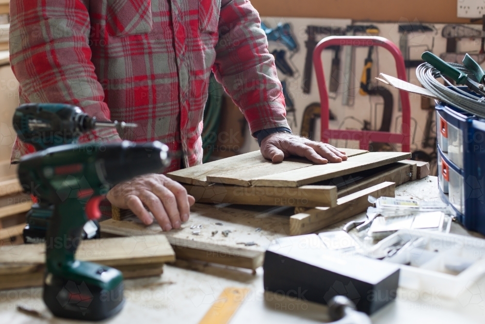 Man working on a project at a men's shed - Australian Stock Image