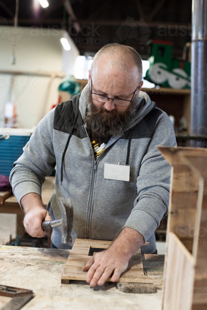 Man working on a project at a Men's shed - Australian Stock Image