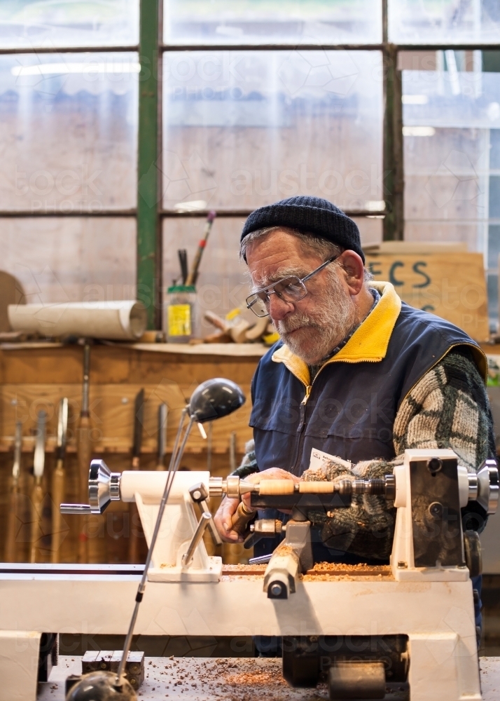 Man working with a lathe at a men's shed - Australian Stock Image
