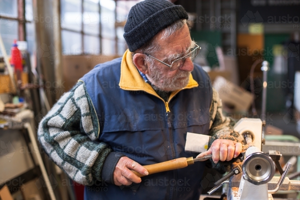 Man working with a lathe in a men's shed - Australian Stock Image