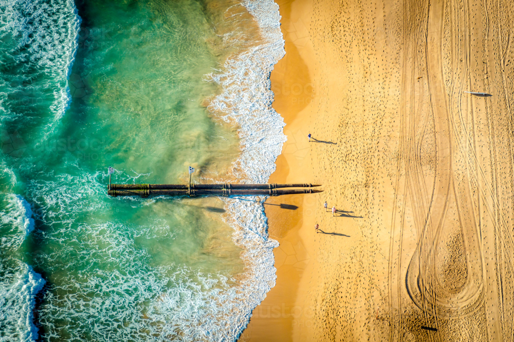 Manly Beach pipes extending from the shore into the turquoise water - Australian Stock Image