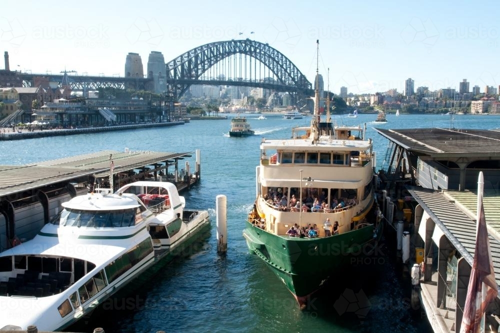 Manly ferry at Circular Quay with Harbour Bridge in the background - Australian Stock Image