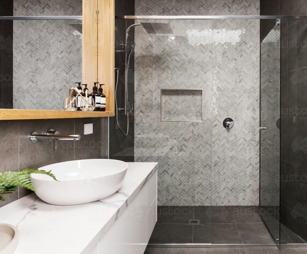 Marble mosaic herringbone tiled shower feature in a contemporary ensuite bathroom - Australian Stock Image