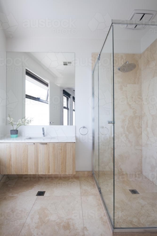 Marble tiled contemporary bathroom in a luxury home - Australian Stock Image