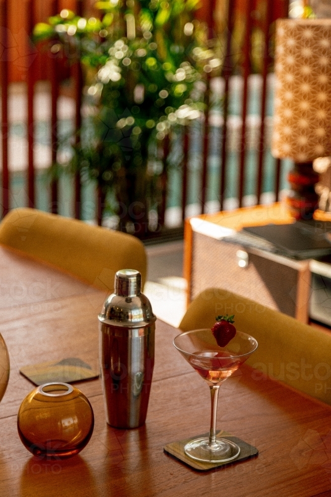 Martini Cocktail and Cocktail Shaker on a Wood Table in a 70's Styled Home - Australian Stock Image