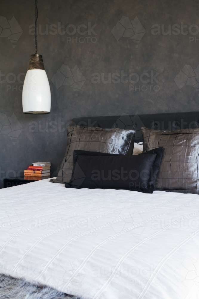 Masculine bedroom decor dark grey painted feature wall - Australian Stock Image