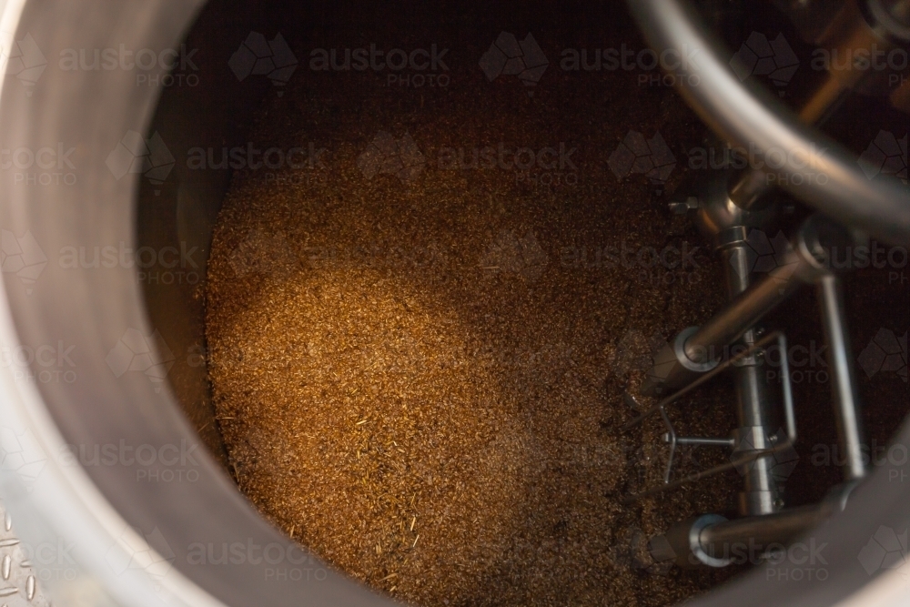 Mash mixing in stainless steel tank at a microbrewery - Australian Stock Image