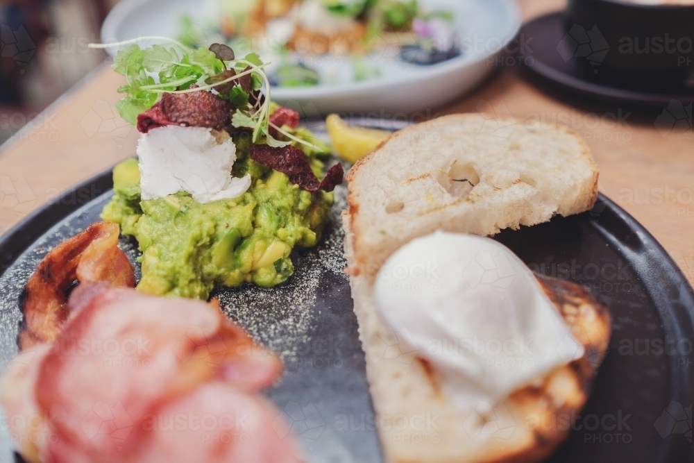 Mashed avocado and poached egg on sourdough toast - Australian Stock Image