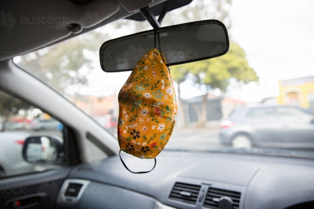 Mask Hanging from a Rear View Mirror - Australian Stock Image