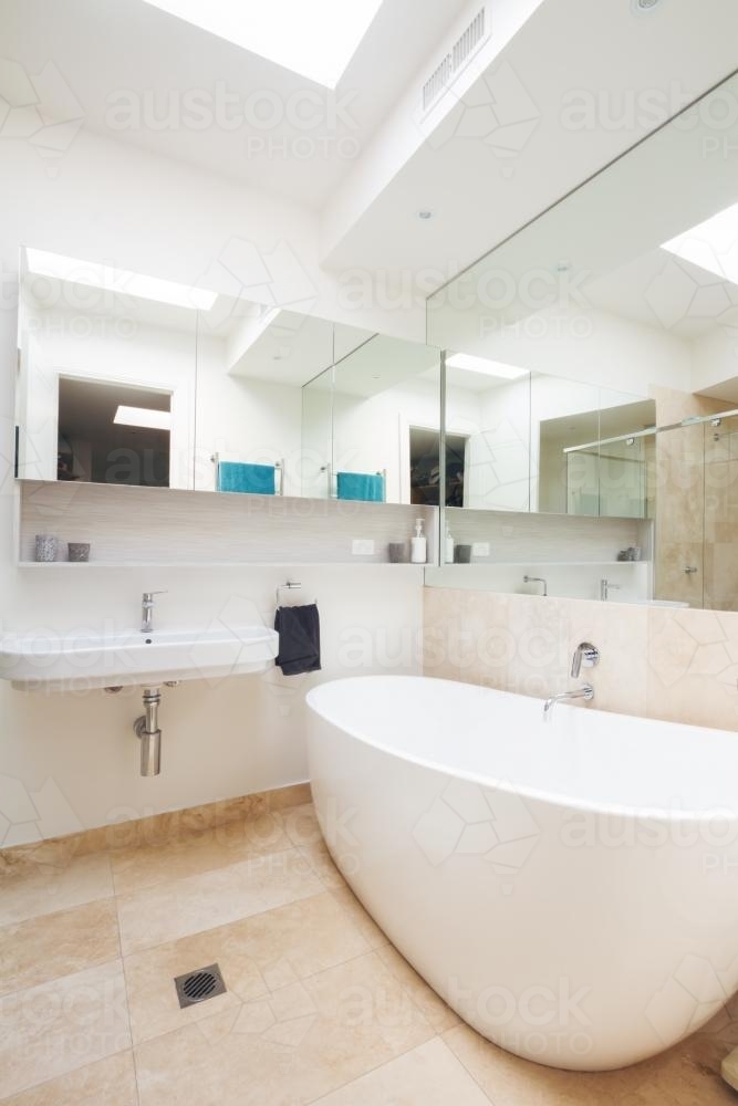 Master bathroom clean white with large bathtub in luxury home - Australian Stock Image