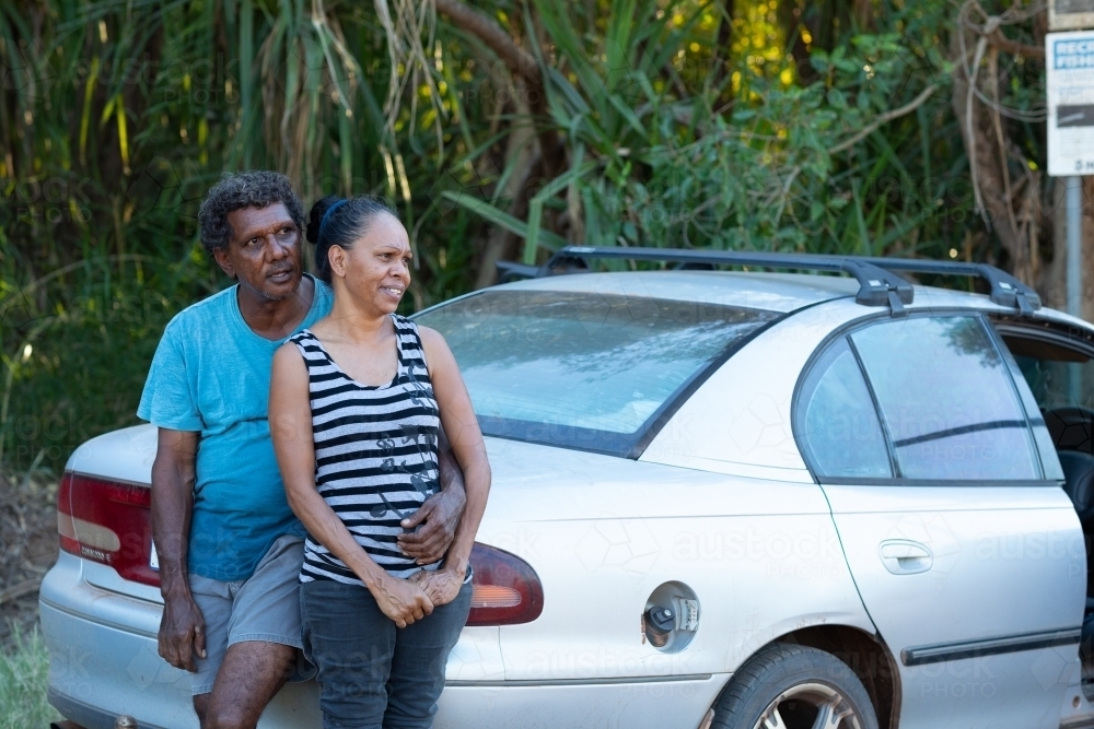 mature couple leaning against car boot - Australian Stock Image
