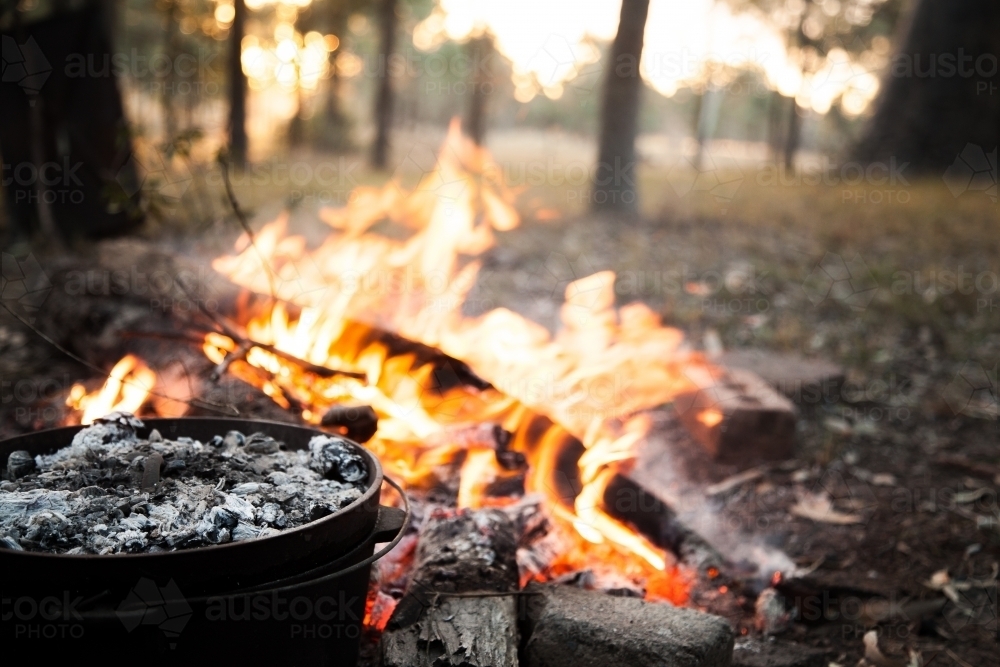 Meal cooking in camping oven over campfires hot coals - Australian Stock Image