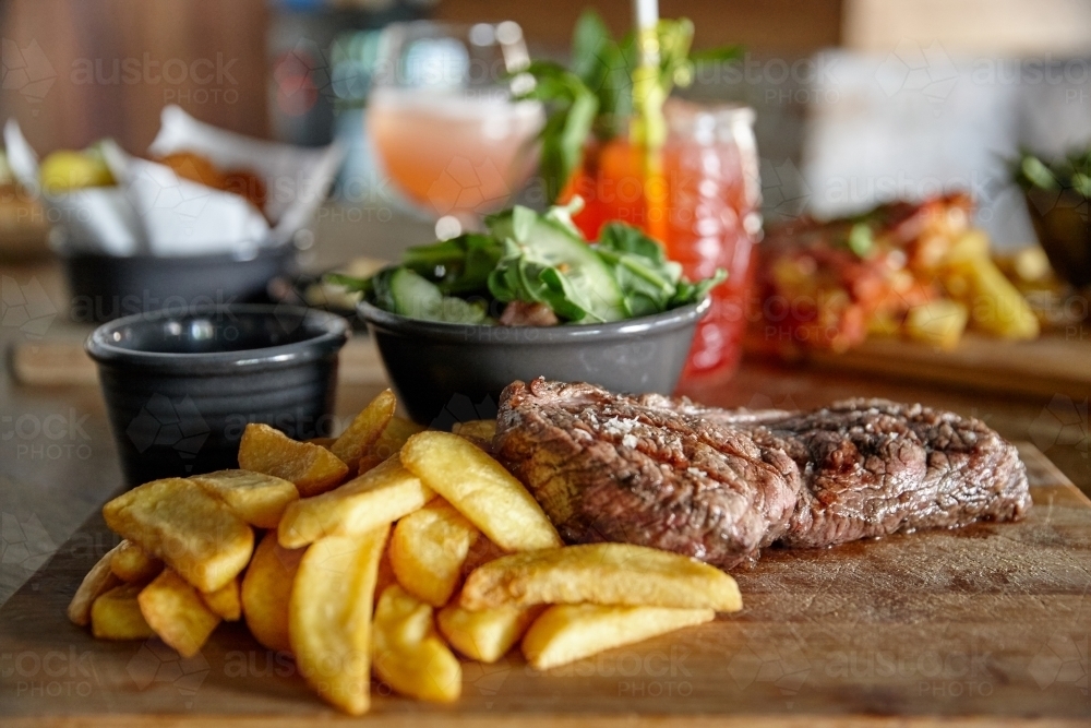 Meal of meat and chips on table - Australian Stock Image