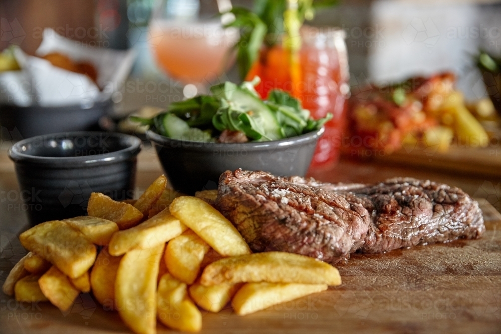 Meal of meat and chips on table - Australian Stock Image