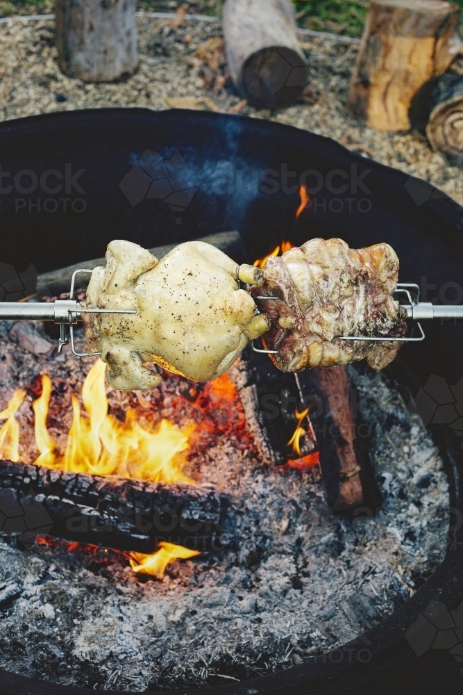 Meats roasting over campfire - Australian Stock Image