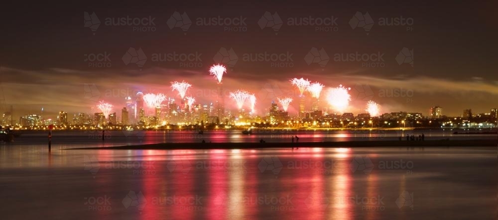 Melbourne CBD fireworks at New Year's Eve from Brighton Pier - Australian Stock Image