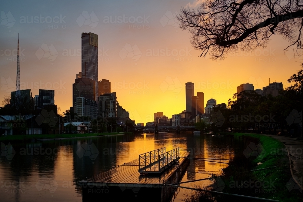 Melbourne CBD with golden sunset from Yarra River - Australian Stock Image