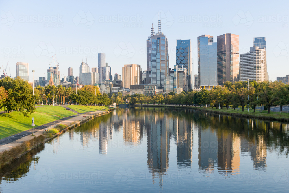 Melbourne city skyline reflected in the Yarra River on a calm morning - Australian Stock Image