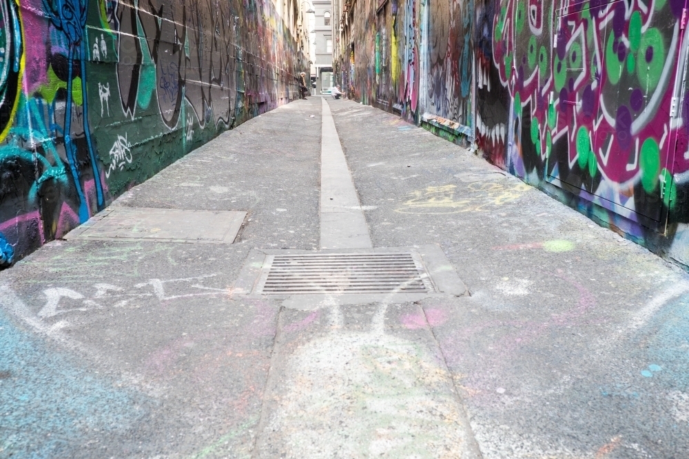 Melbourne laneway with street artist at work in the distance - Australian Stock Image